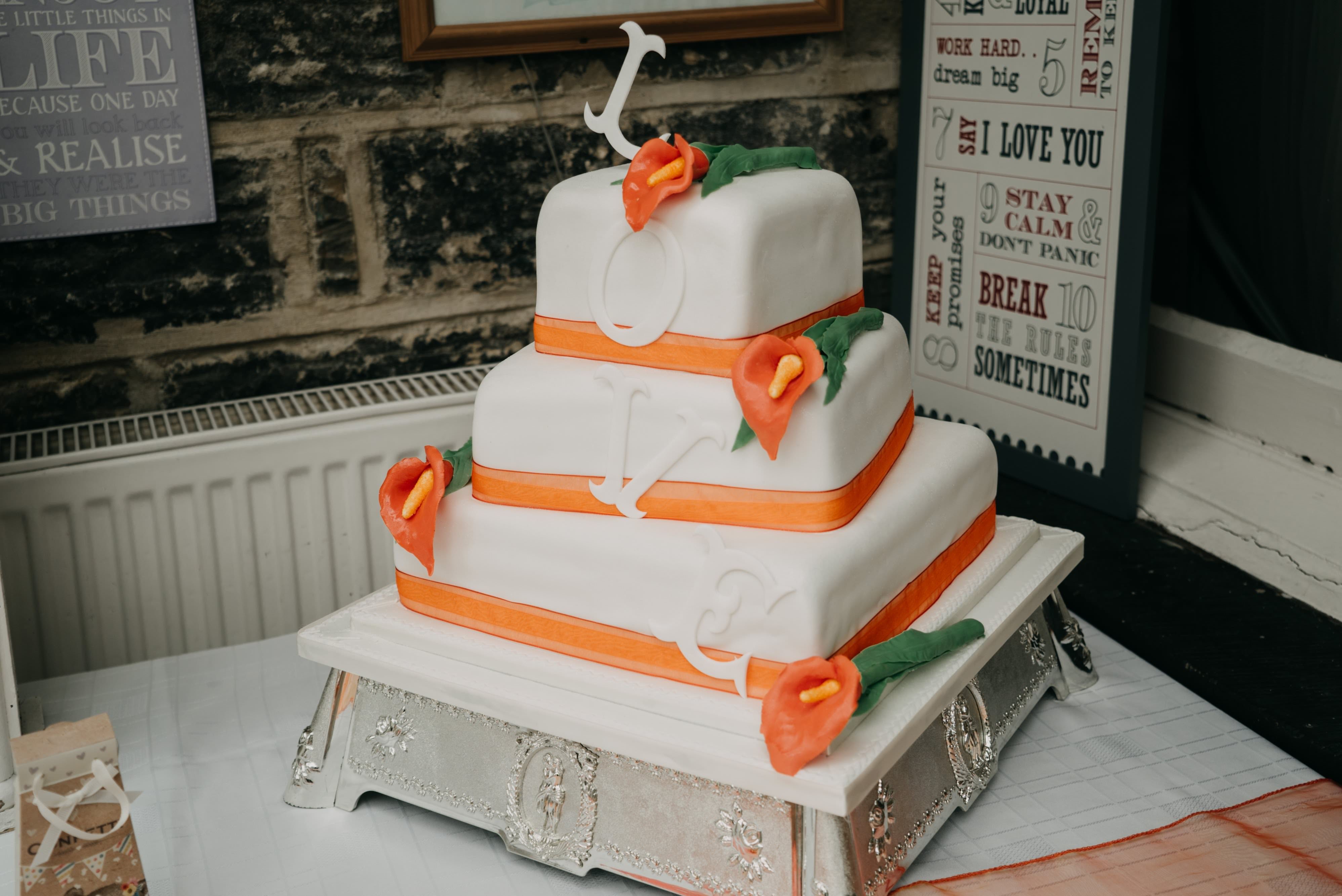 Simple white and orange wedding cake