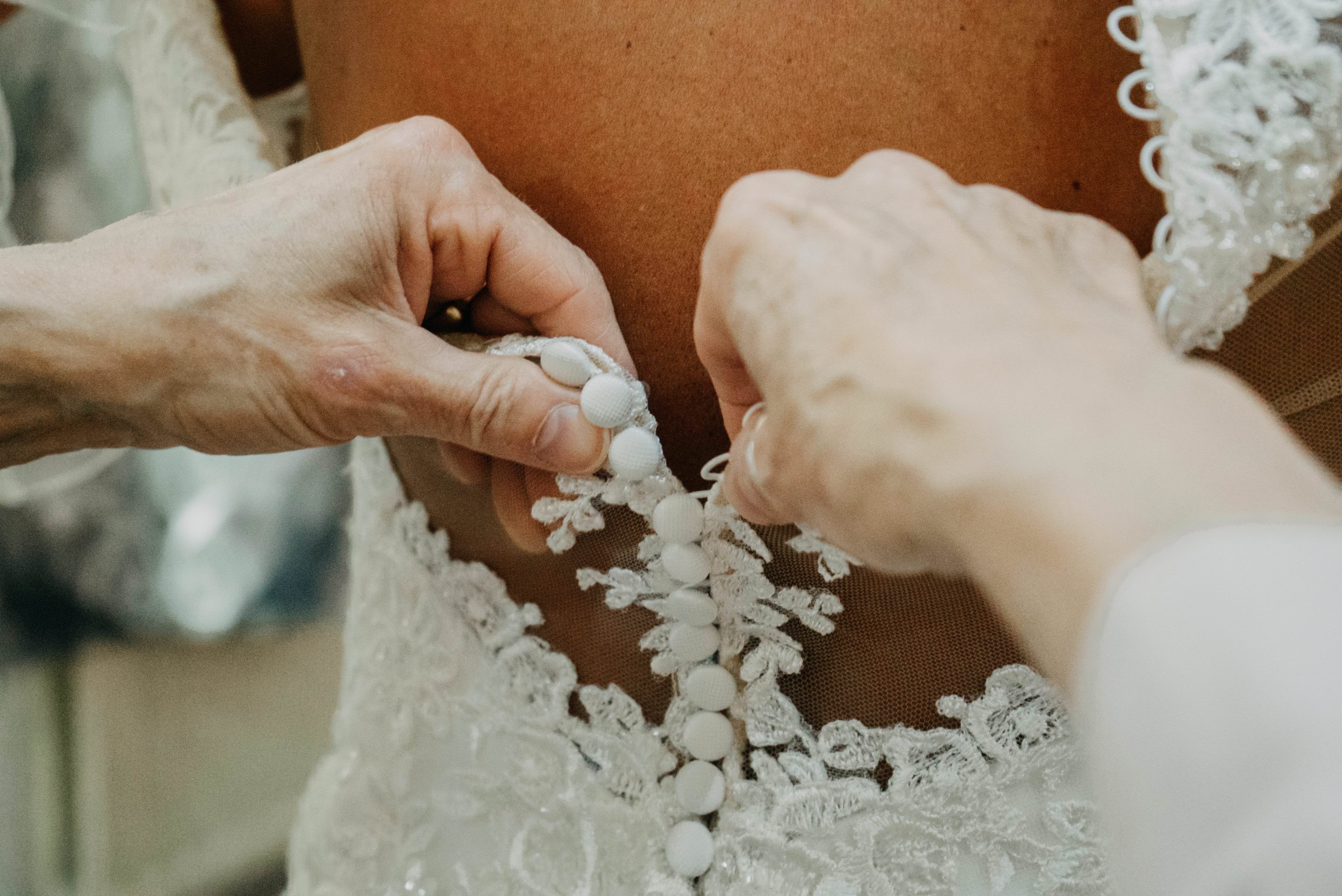 bride getting in dress