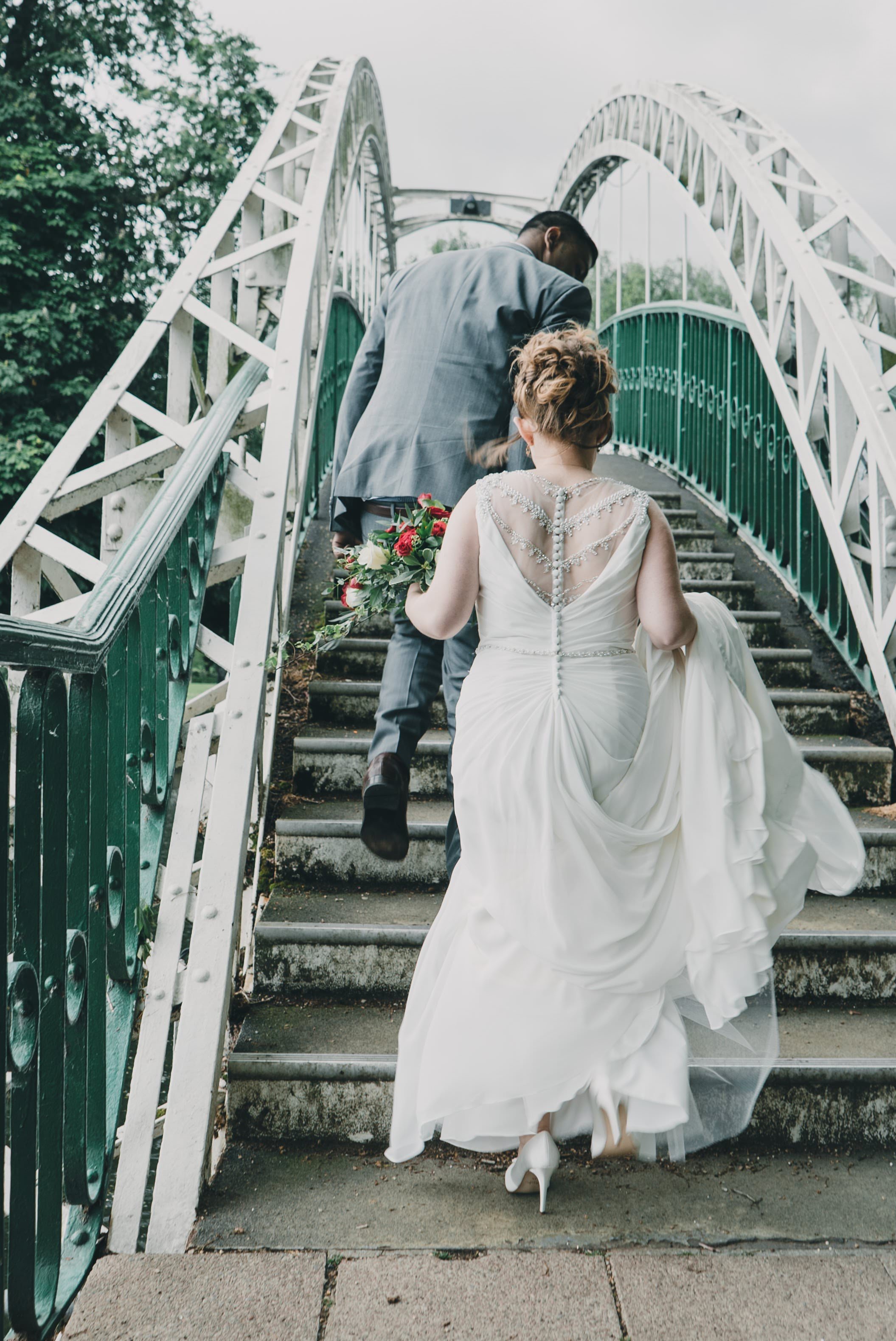bride going up embankment stairs