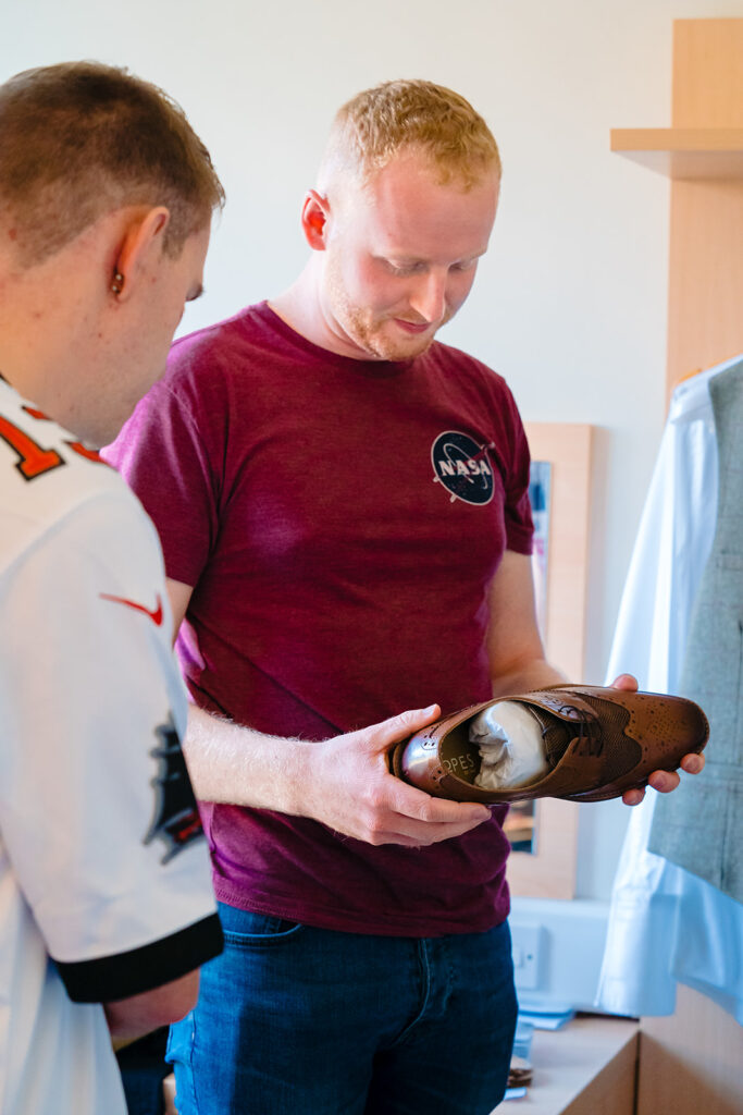 Man in NASA shirt holding space artifact with colleagues