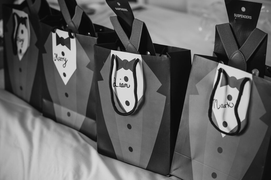 Black and white tuxedo-themed gift bags with personalised name tags