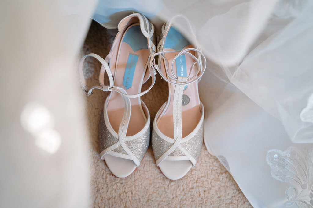 Elegant white and silver bridal heels with ankle straps