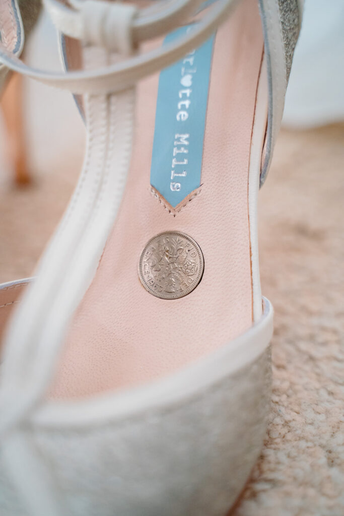 Ballet pointe shoe with coin emblem and blue label