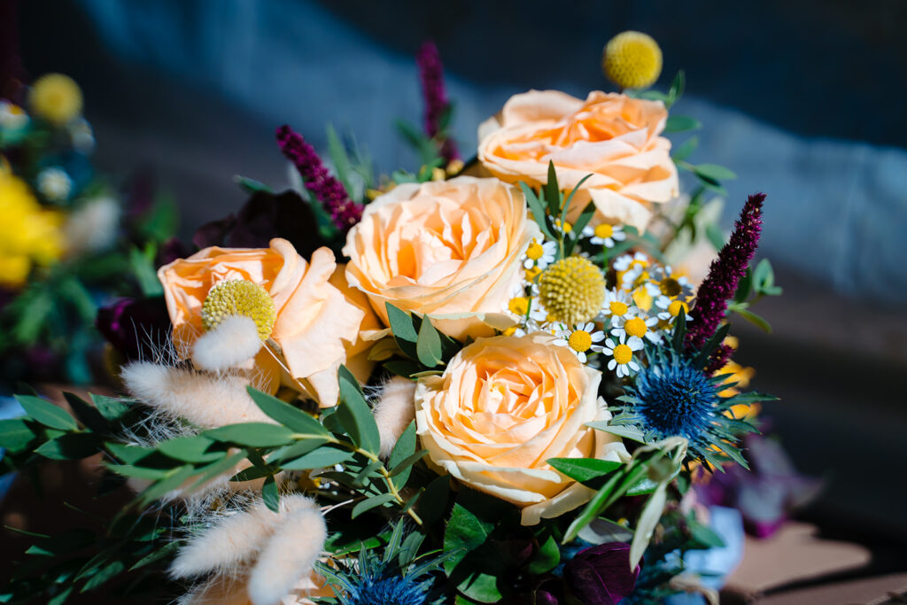Vibrant floral bouquet with peach roses and colourful flowers