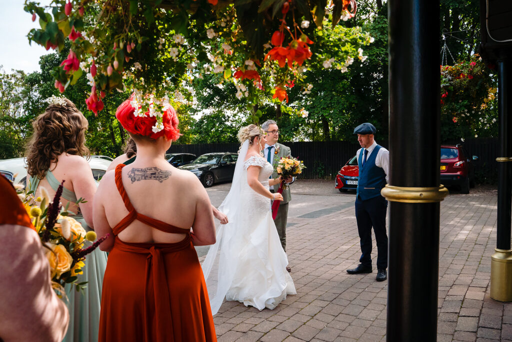 Bride in white dress with groom at outdoor wedding ceremony