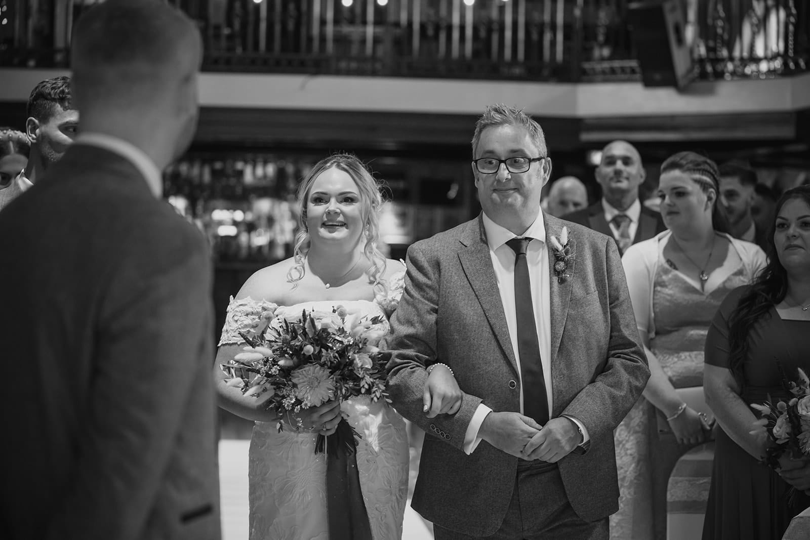 Bride and groom walking down aisle at wedding ceremony