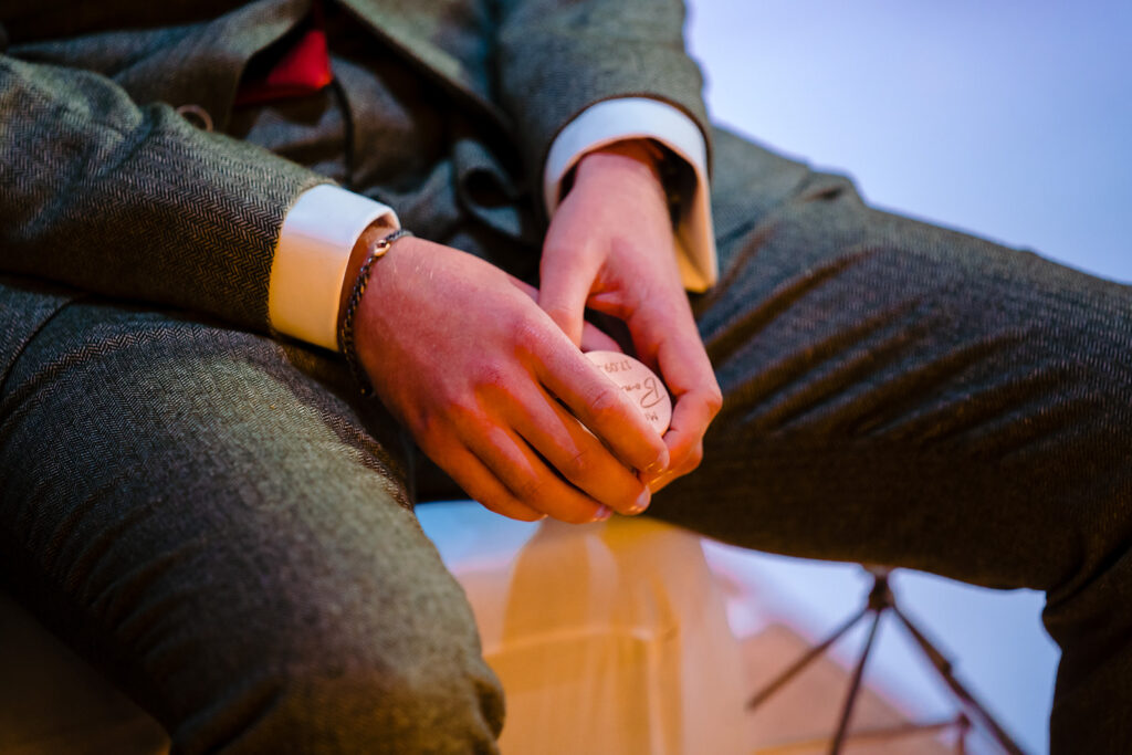 Child's hands holding parent's hand wearing winter clothing