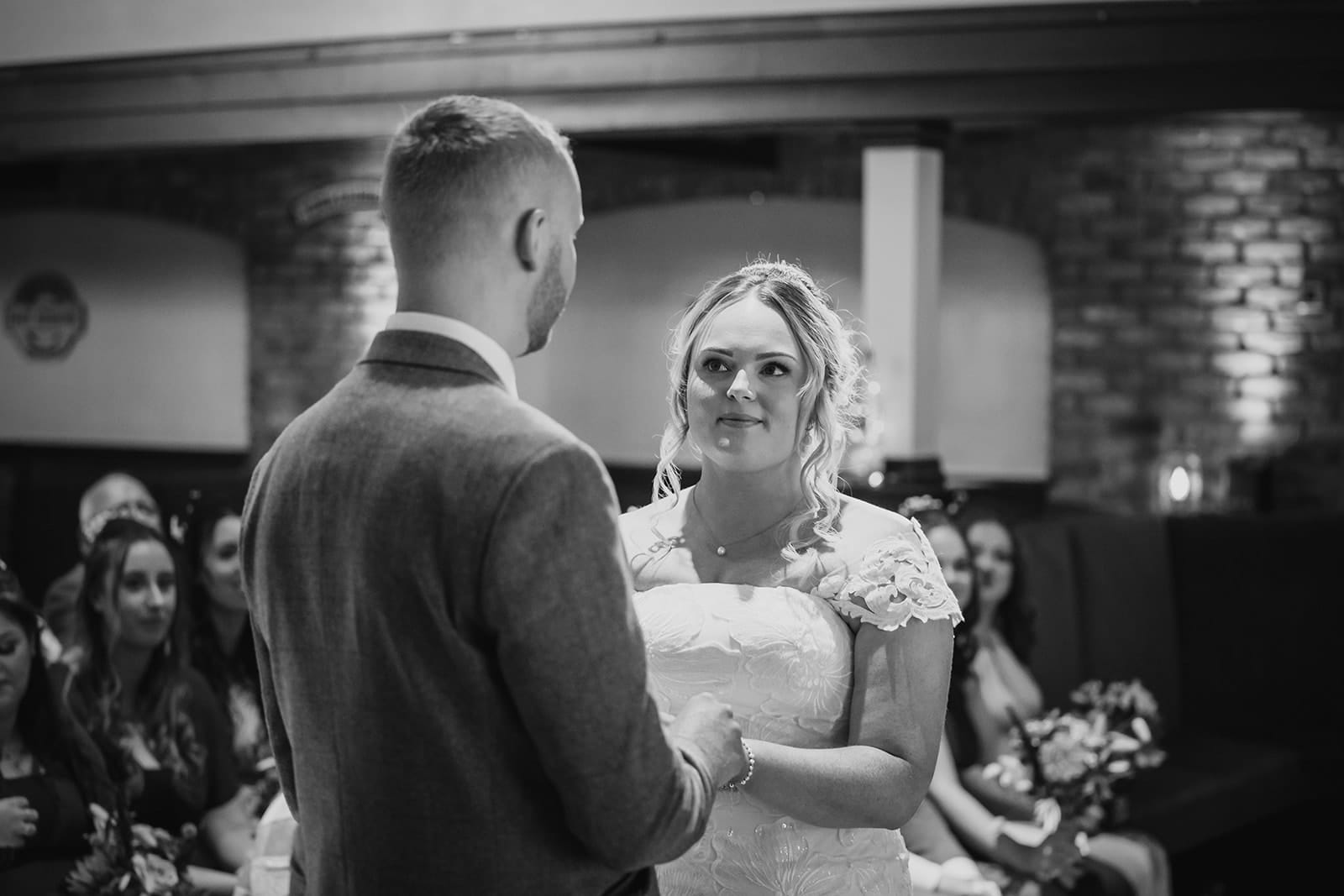 Bride and groom exchanging vows at wedding ceremony