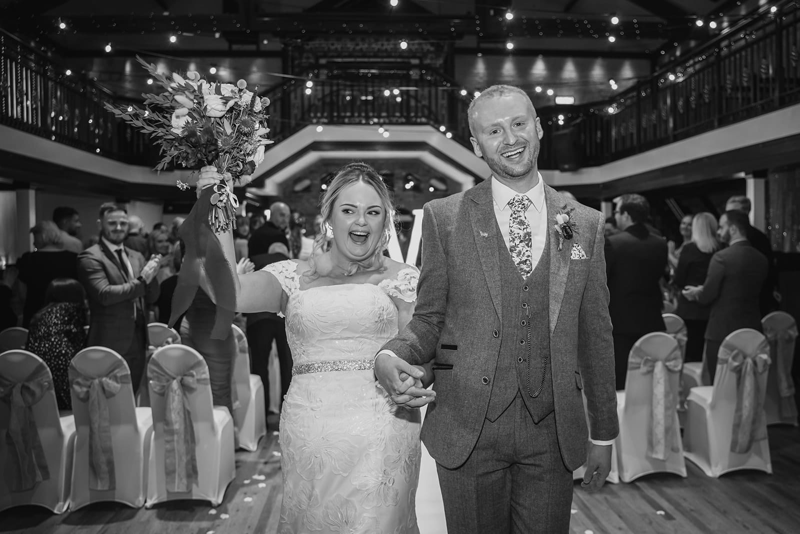 Bride and groom walking down aisle at elegant wedding ceremony