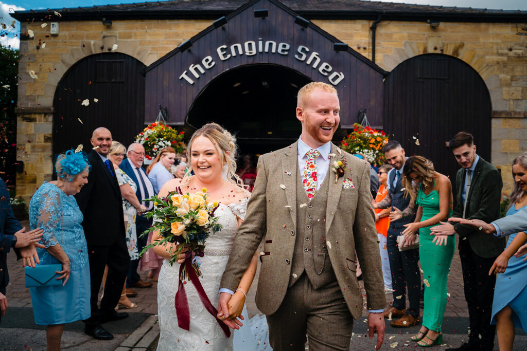 Bride and groom exit wedding ceremony at The Engine Shed venue