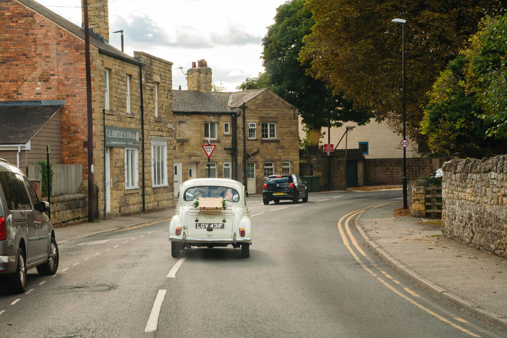 Vintage white Citroën 2CV car on English village street