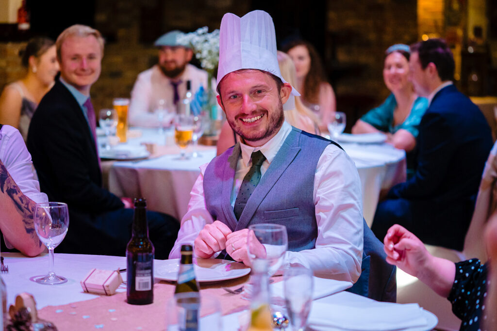 Man wearing chef's hat at formal dinner party celebration