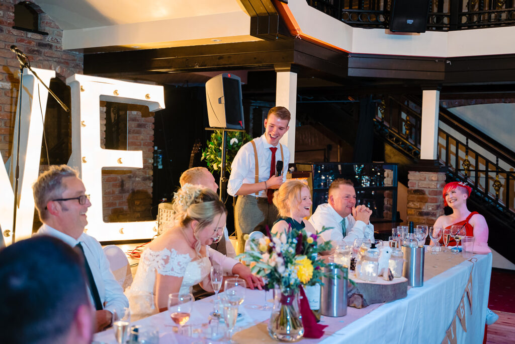 Best man giving toast at wedding reception dinner