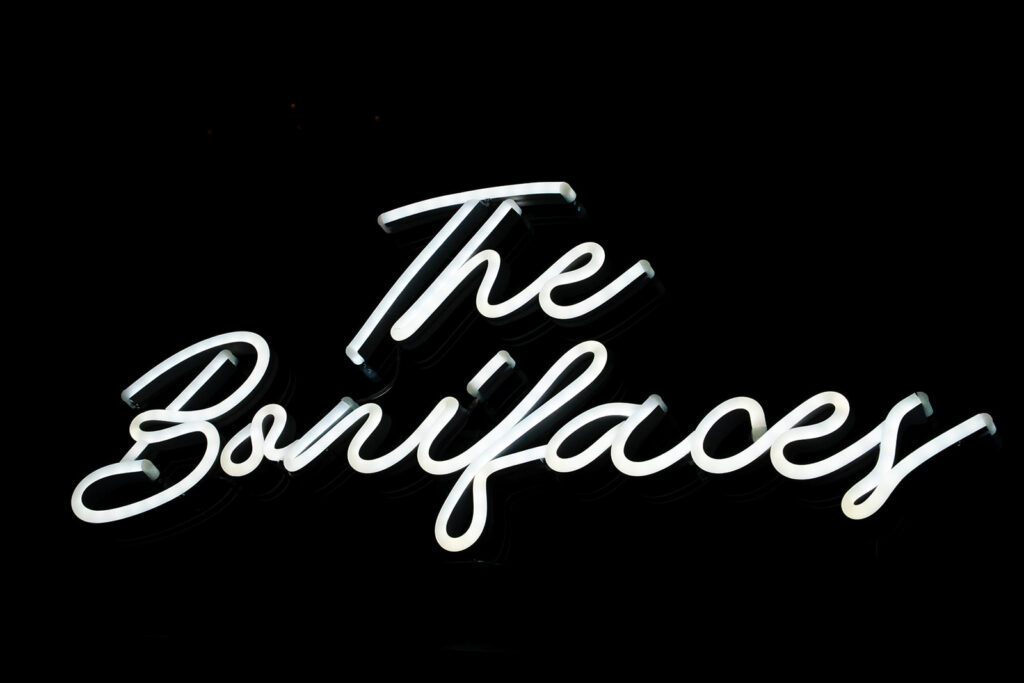 The Benflayer neon sign glowing white on black background