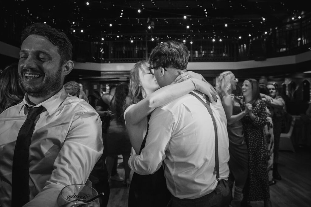 Black and white wedding reception dance floor celebration with guests