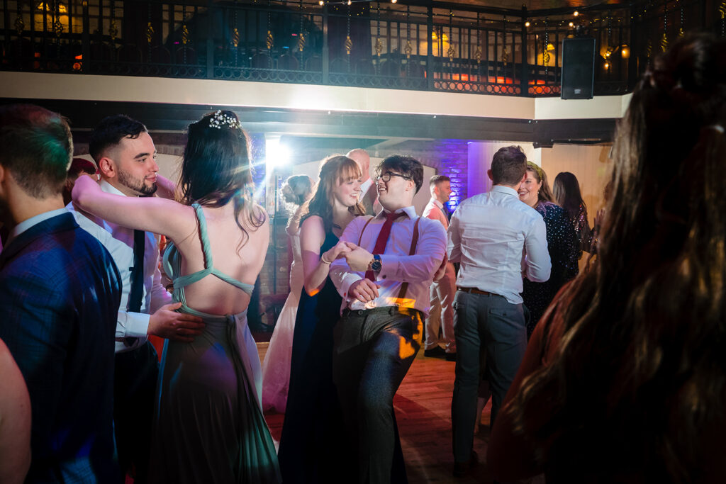 Guests dancing at elegant indoor wedding reception venue