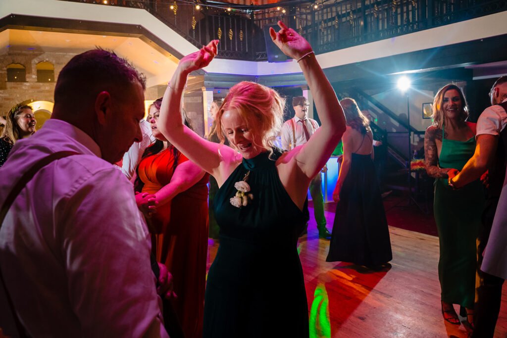 People dancing at lively nightclub party with colourful lighting