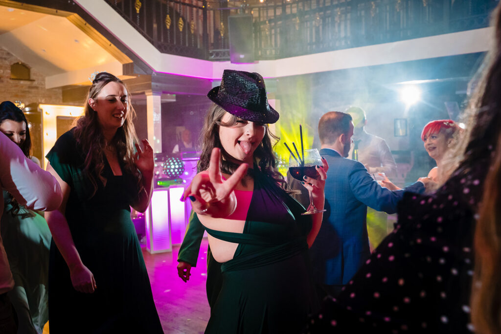 People dancing at vibrant nightclub party with neon lights