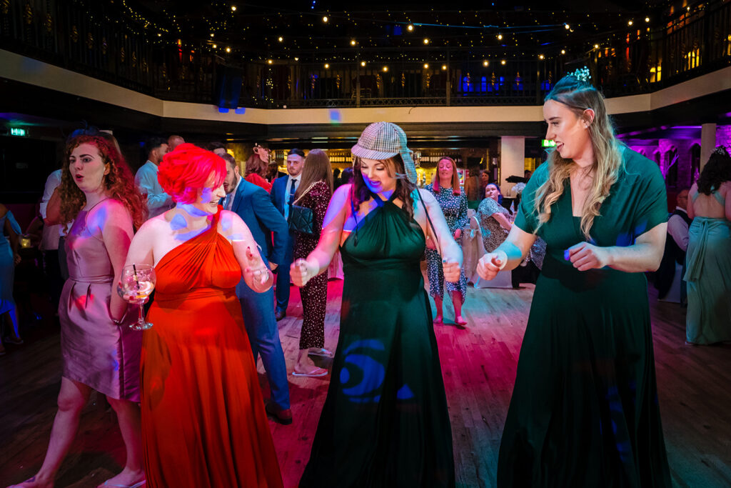 People dancing at elegant indoor venue with colourful lighting