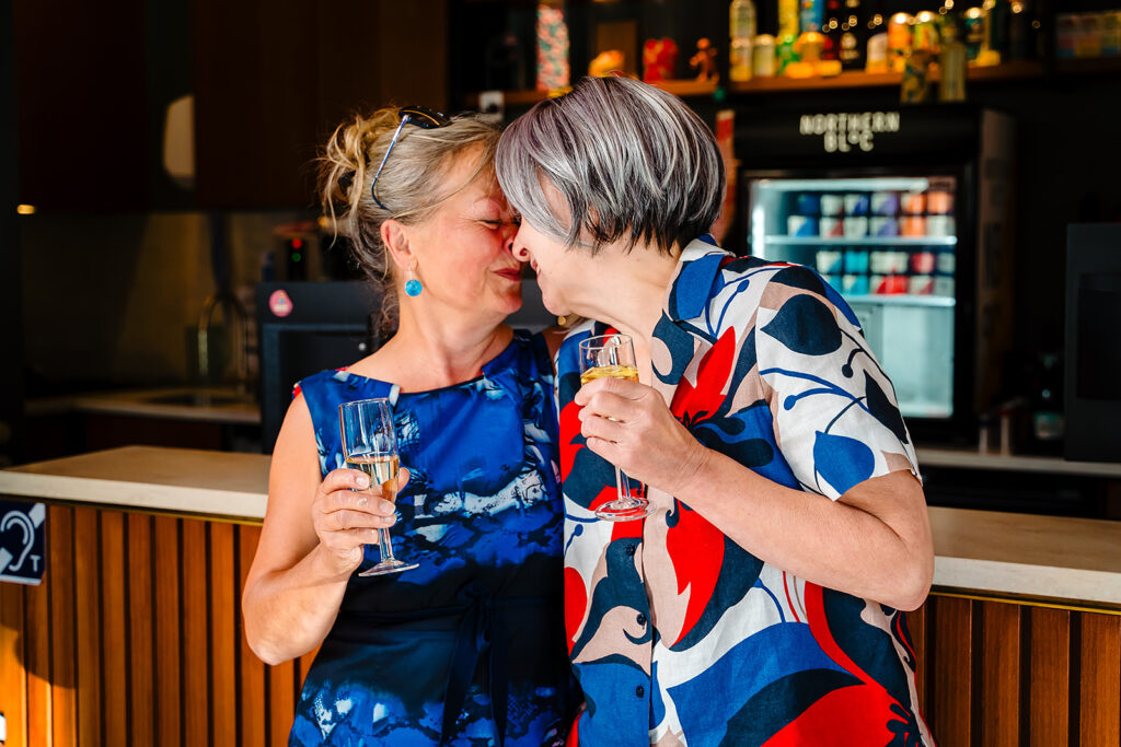 A bride sharing a hug with a guest at the Hyde Park Picture House bar