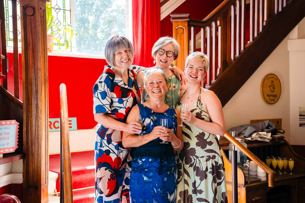 Beverly and Jane laughing with friends at the foot of the Hyde Park Picture House staircase