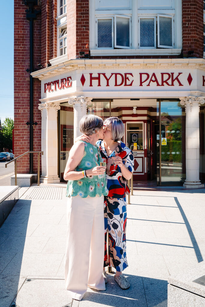 Beverly and Jane kissing under the Hyde Park Picture House sign on Brudenell Road