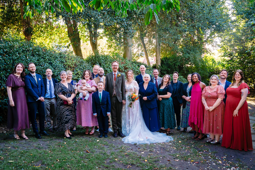 Ellissa and Anthony with all their wedding guests in a sunny York garden