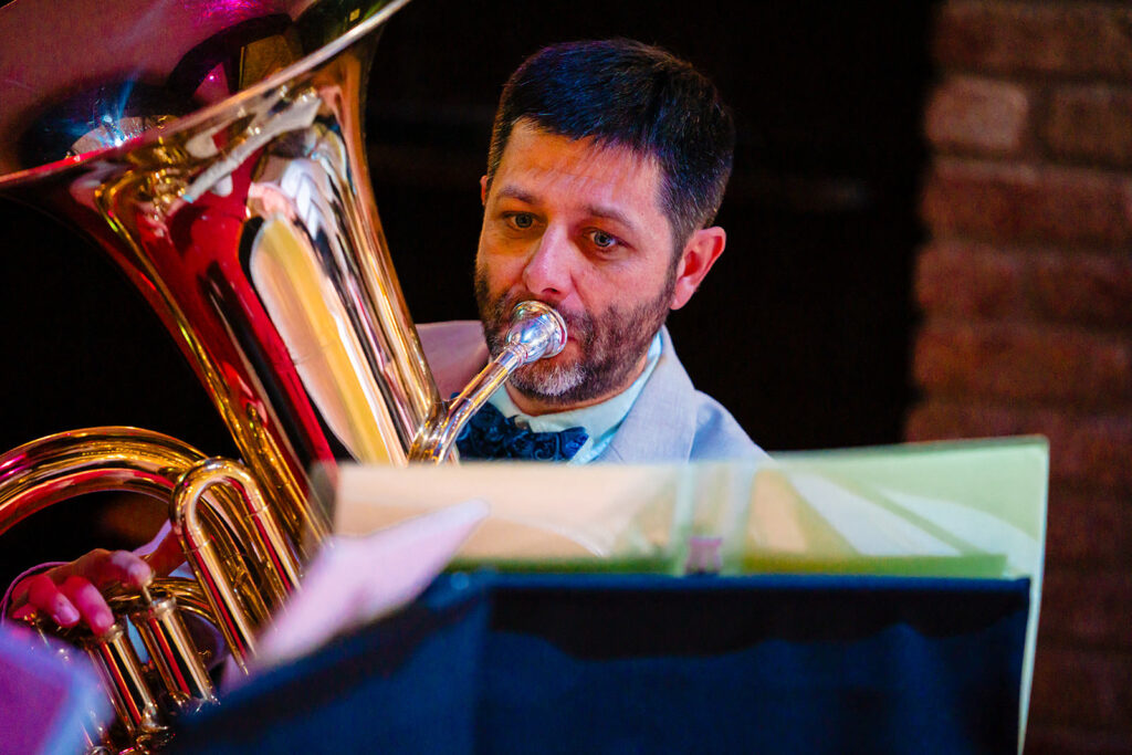 One of the couple's friends playing tuba in the quartet during the wedding ceremony at the Engine Shed