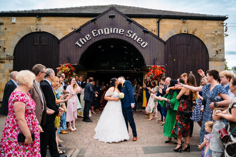 Fran and Andy kiss as guests throw confetti outside the front of the Engine Shed in Wetherby