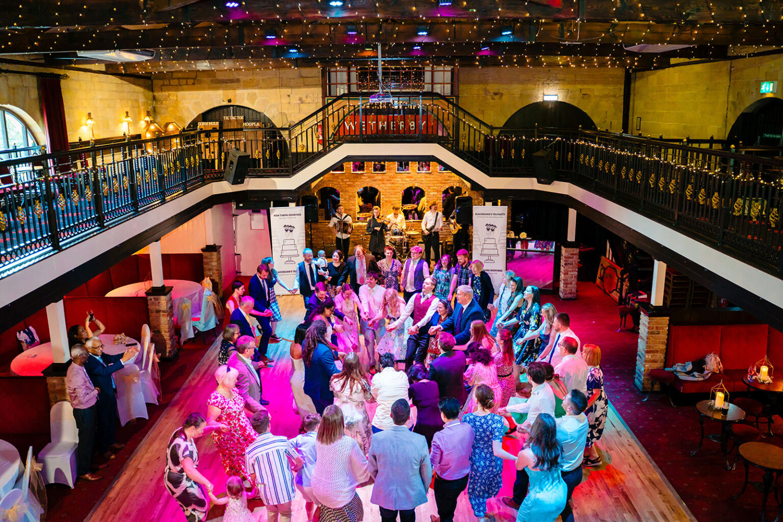 The whole dance floor dancing a ceilidh at the Engine Shed, seen from the Mezzanine above
