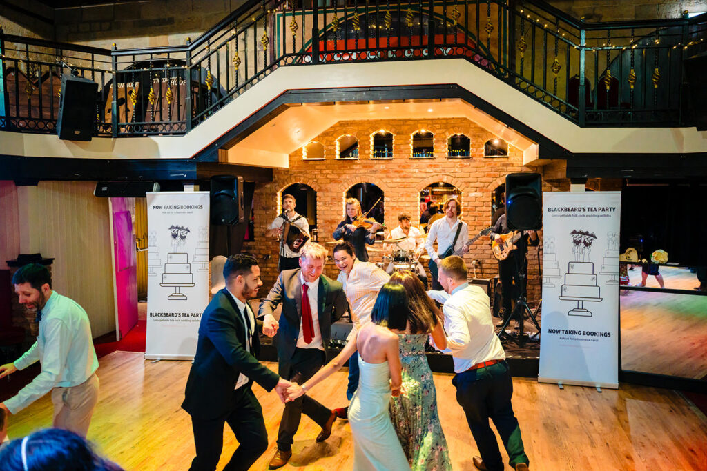 Blackbeard's Tea Party playing a folk-rock ceilidh on the Engine Shed stage while guests dance