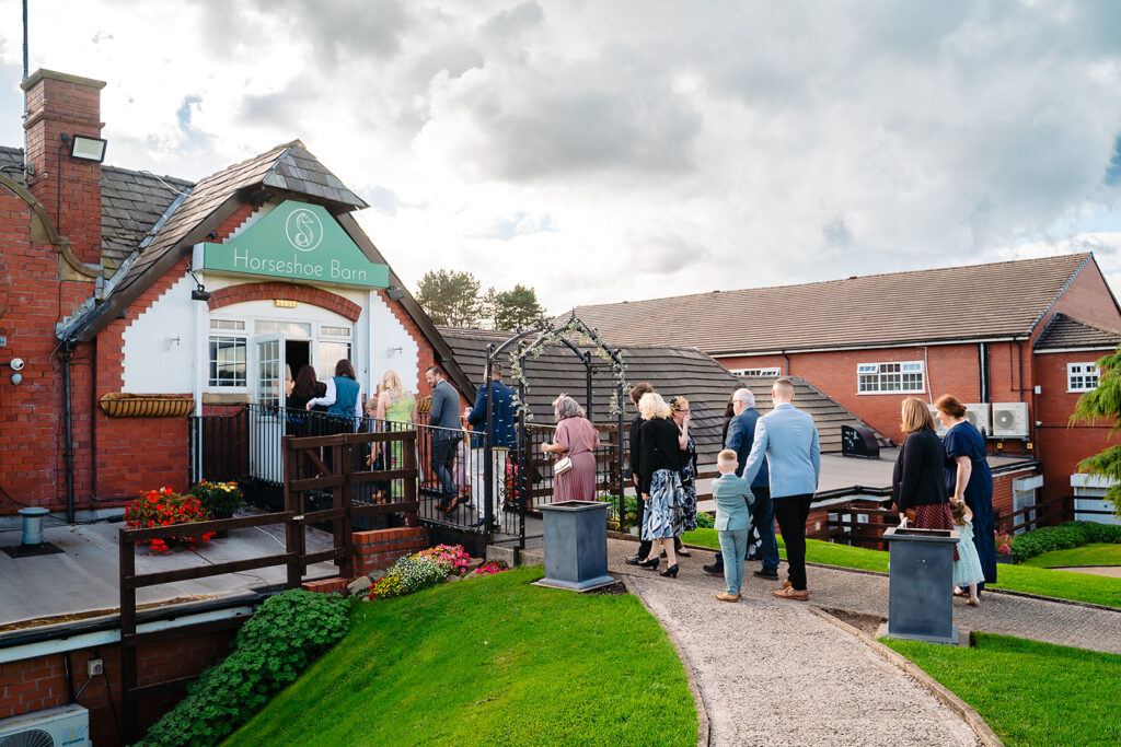 Wedding guests arriving at the Horseshoe Barn at the Stables Country Club, Bury