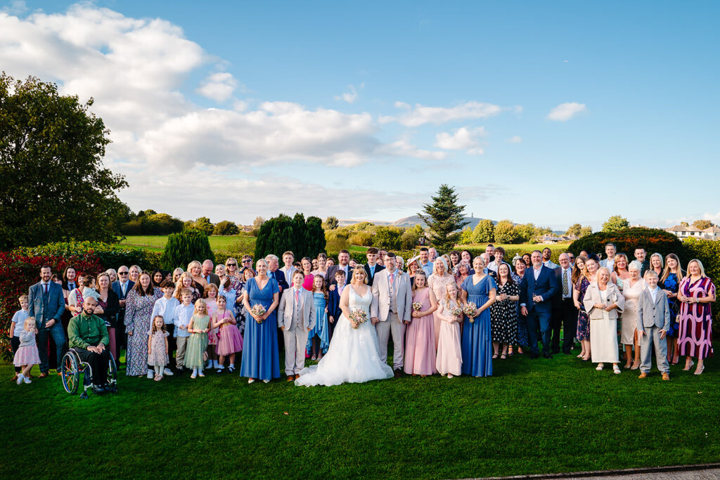 All of Kay and Steven's wedding guests together on the lawn at the Stables Country Club, Bury
