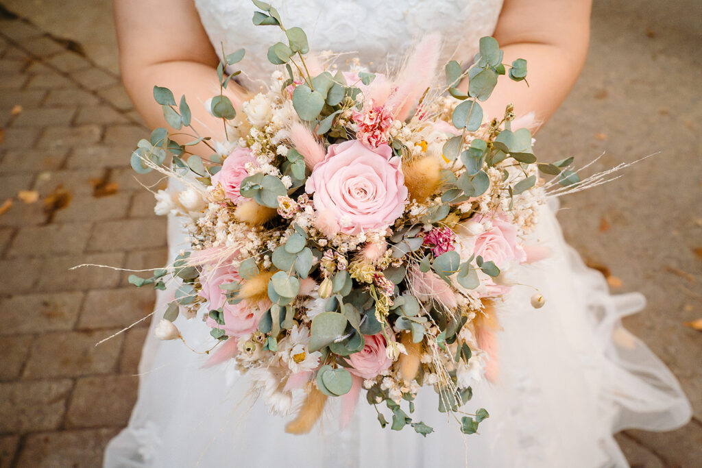 Boho dried-flower bridal bouquet of pink roses, pampas grass and eucalyptus