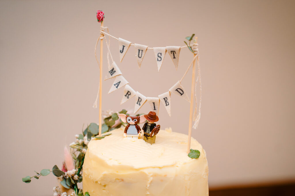 Just Married bunting cake topper with LEGO Gizmo and Indiana Jones minifigures