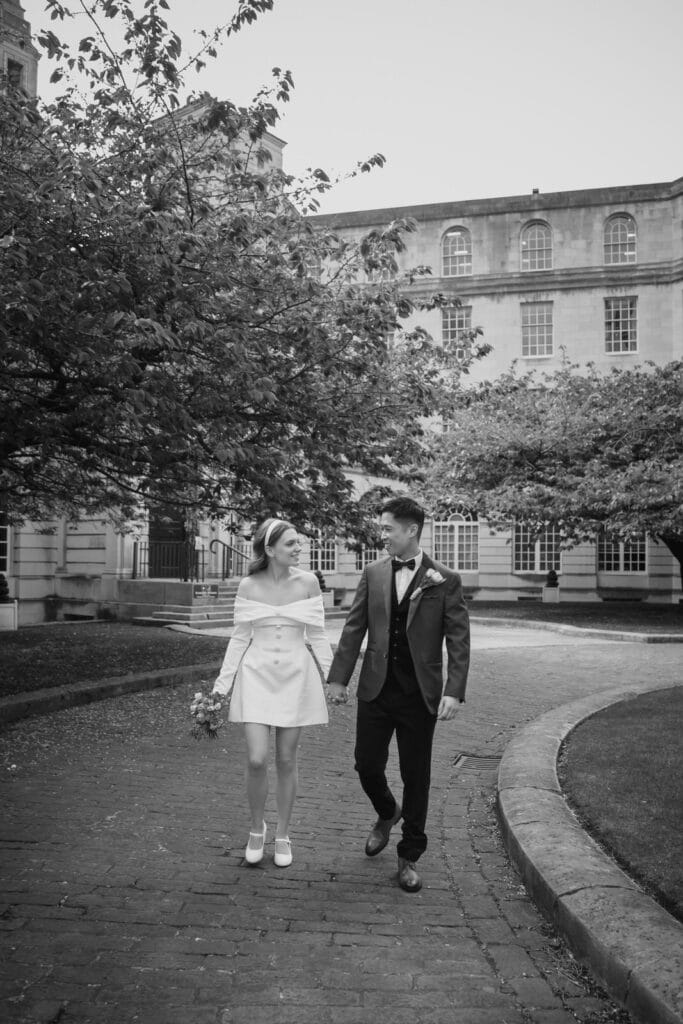 Married couple happily walking outside Leeds Civic Hall