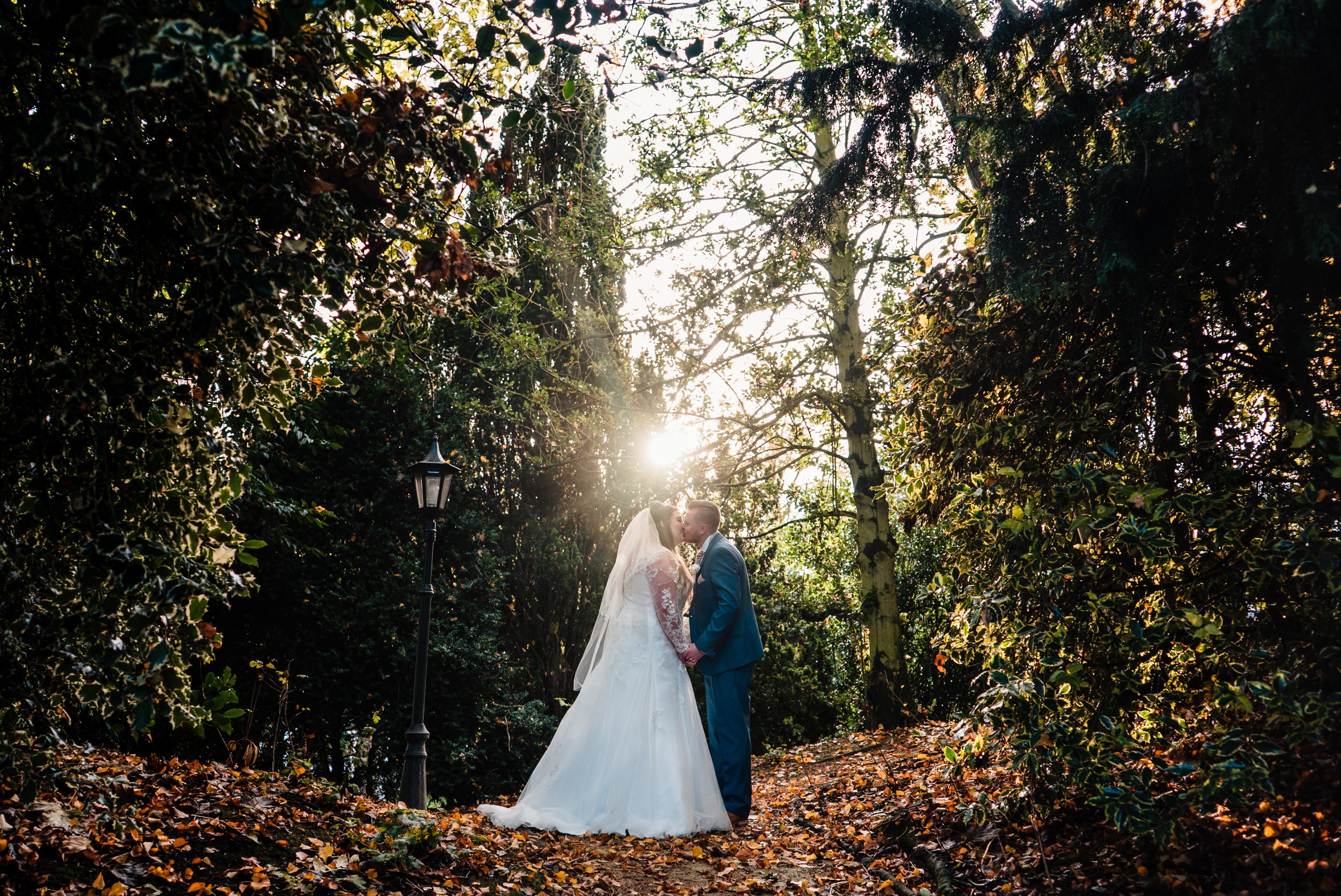 Groom and Bride kissing in the grounds of the Marriott Hotel