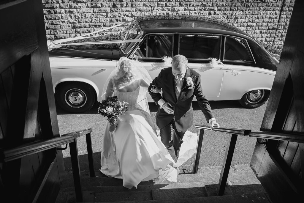 Rebecca and Nicholas kissing at the front of Dewsbury Baptist Church as their guests watch
