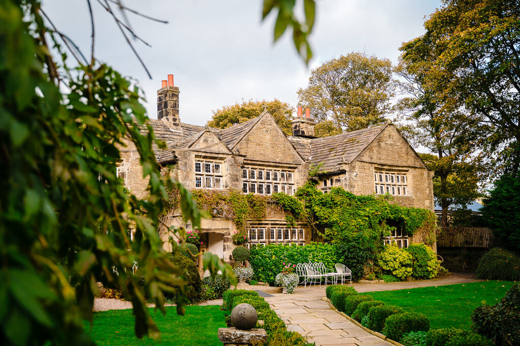 Holdsworth House, a 1633 Jacobean manor in Halifax, seen across its gardens in autumn
