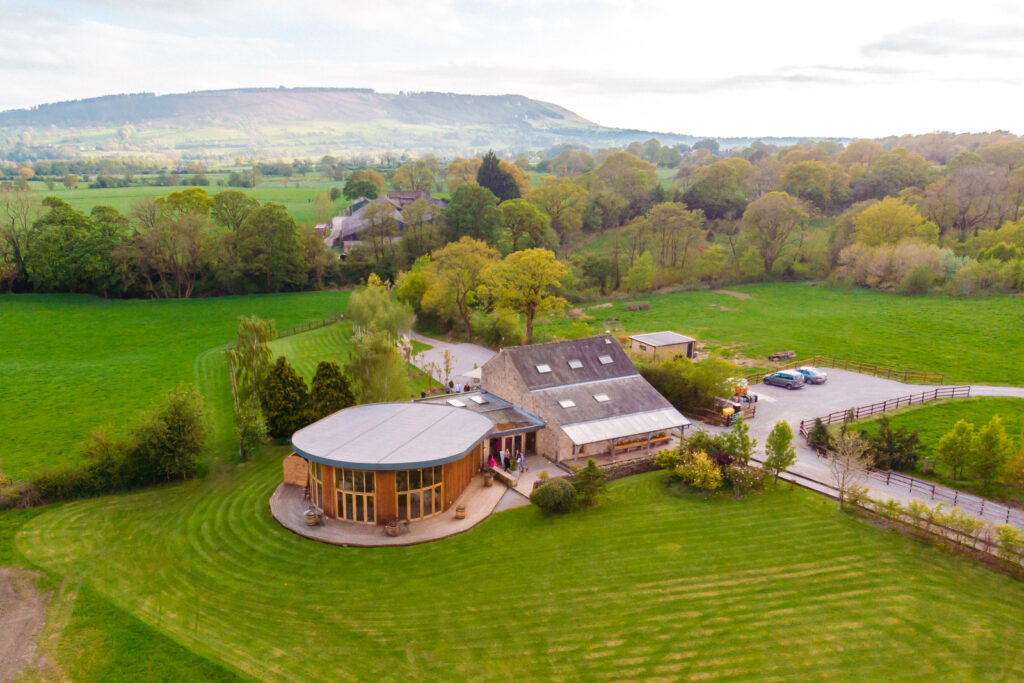 Aerial view of countryside The Out Barn and lush green fields.