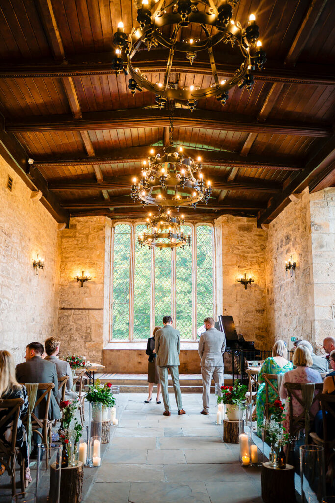 Ceremony setup inside the Priests House with rustic decor and flowers